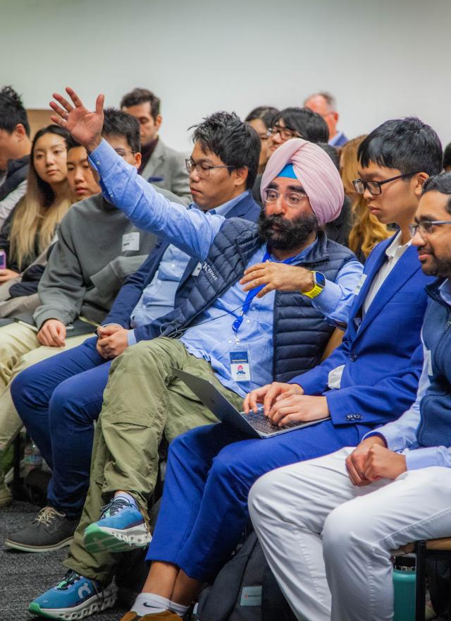 Jagdeep Singh Bachher sitting in a front row seat in a classroom