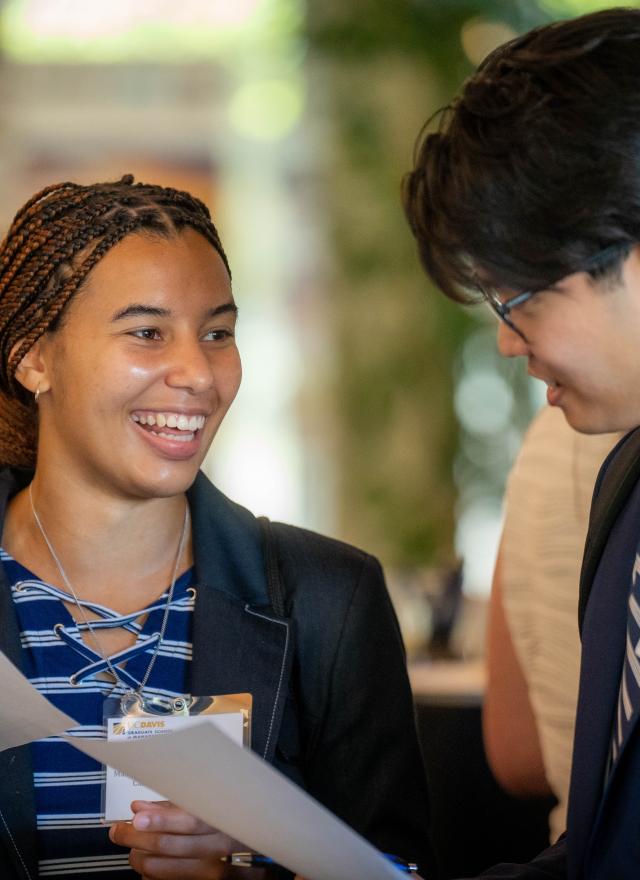 two MBA students dressed in business attire