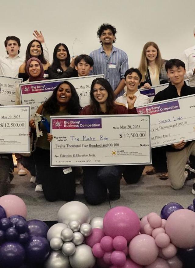 winners on stage with checks