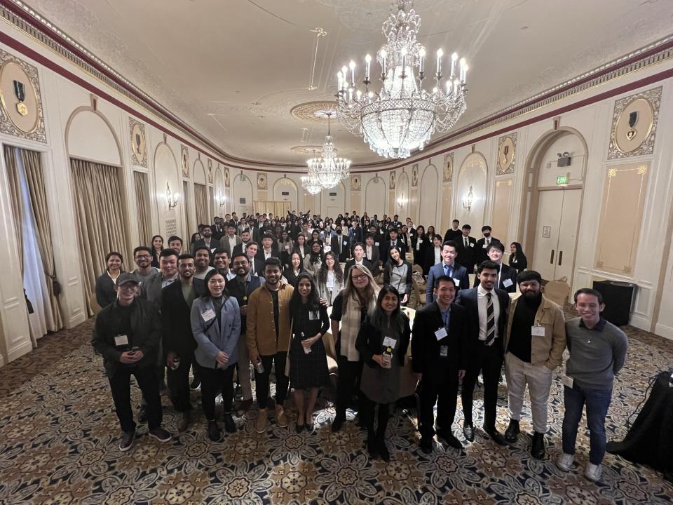 large group of people standing in hotel lobby