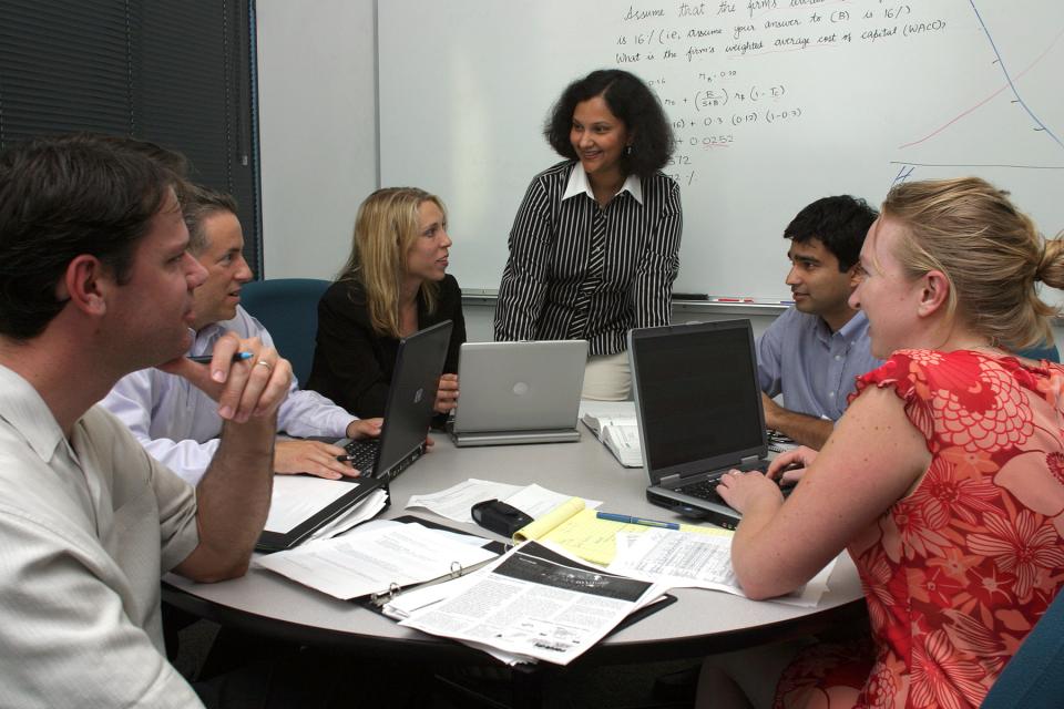 Working Professional MBA students collaborate in team at One Capitol Mall.