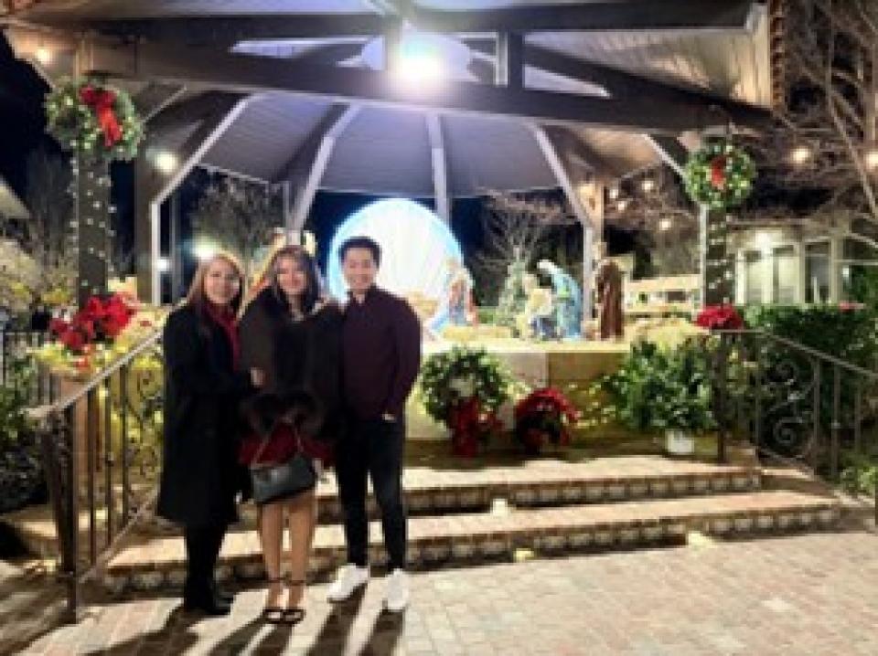 Curtis Choi under a gazebo with two women