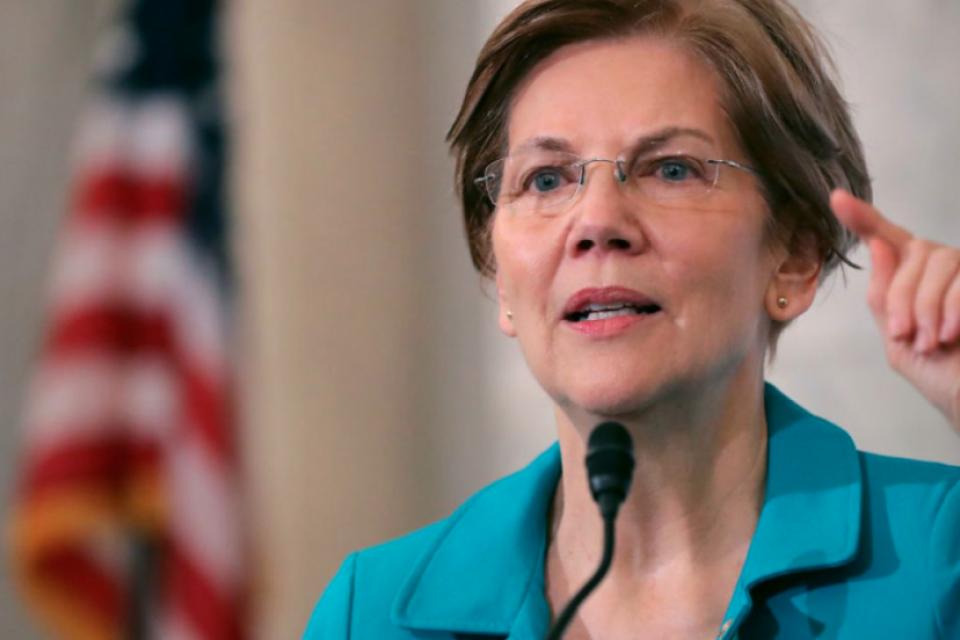 Elizabeth Warren speaking on a podium