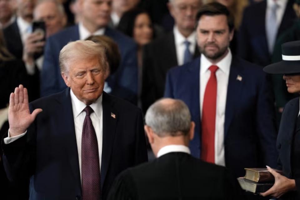 Trump raising his right hand and taking the oath at his inauguration